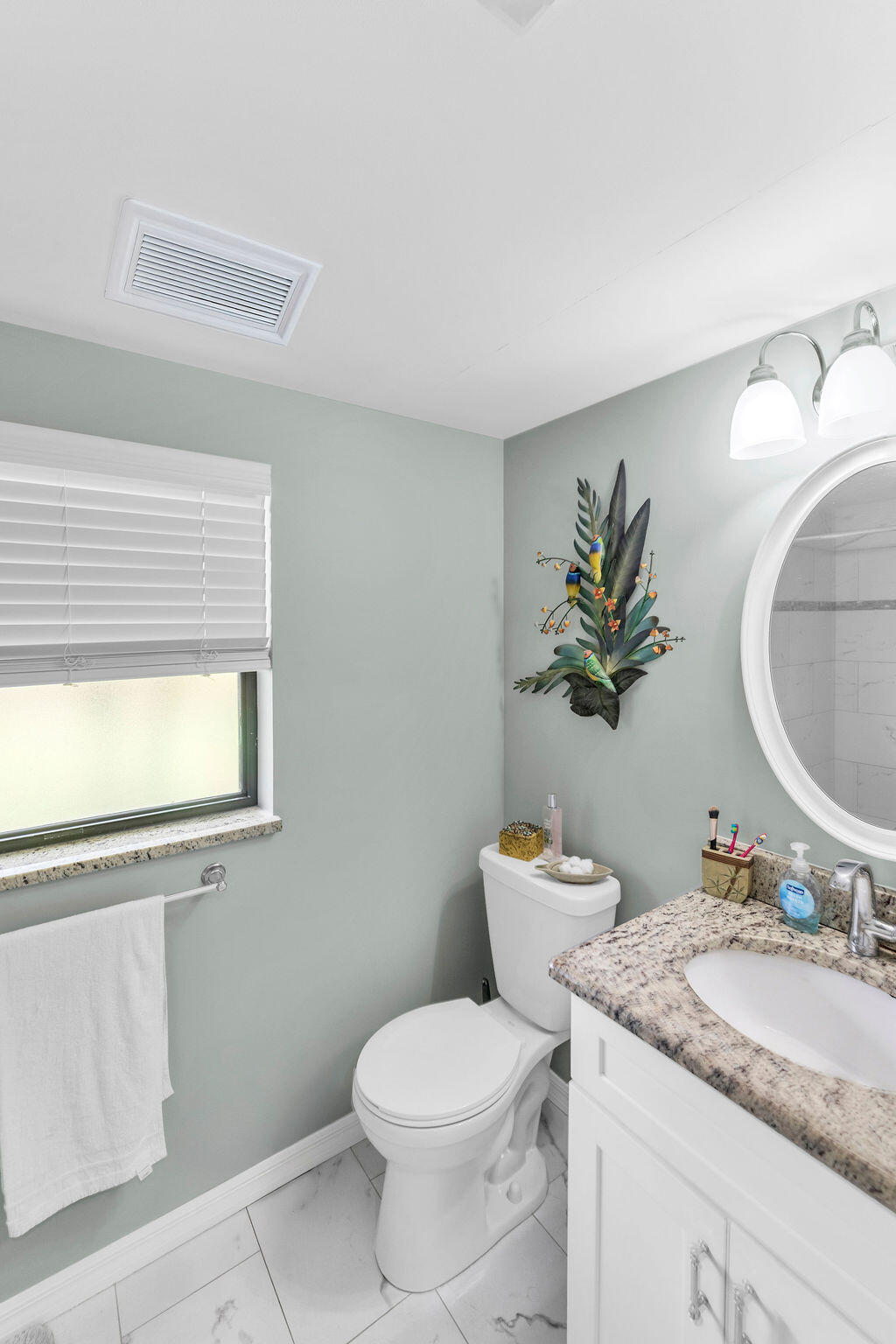 2402 Southeast Pinero Road Port St. Lucie, FL 34952 - Photo 44 of 45 a bathroom with a granite countertop sink and a mirror