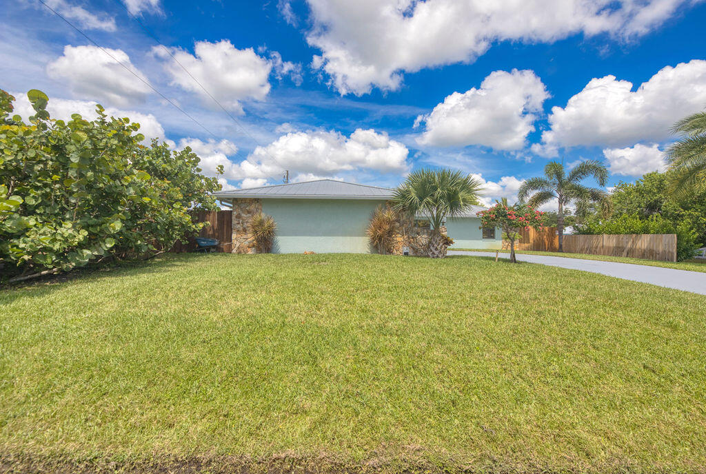 2402 Southeast Pinero Road Port St. Lucie, FL 34952 - Photo 5 of 45 a view of a house with a yard