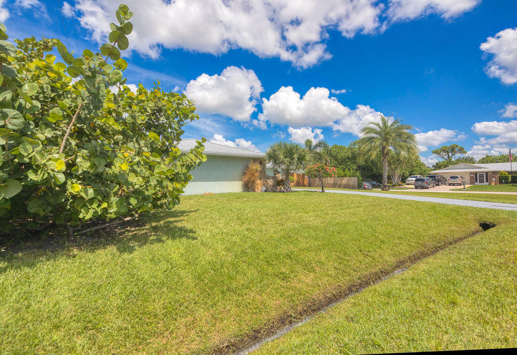 2402 Southeast Pinero Road Port St. Lucie, FL 34952 - Photo 6 of 45 a view of a lake with a building in the background