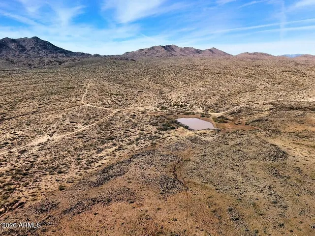 a view of mountain with sunset in background