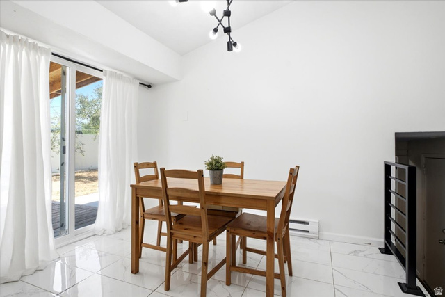 7989 Washington Road Magna, UT 84044 - Photo 12 of 30 Dining area featuring white walls, glossy white tile flooring, and a modern multi-bulb ceiling fixture