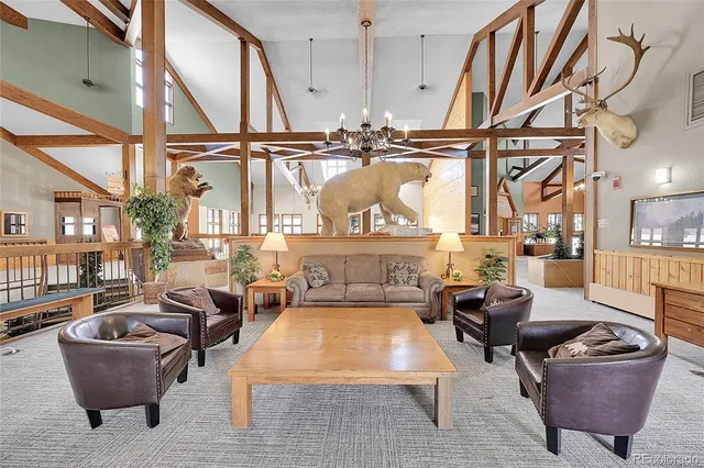 a living room with furniture a fireplace and a large mirror