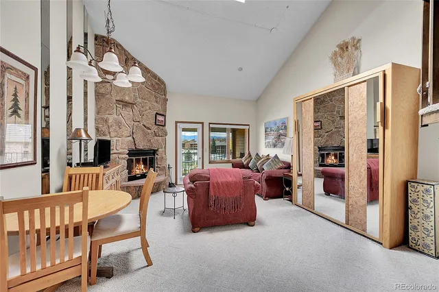 a living room with furniture a flat screen tv and a large window