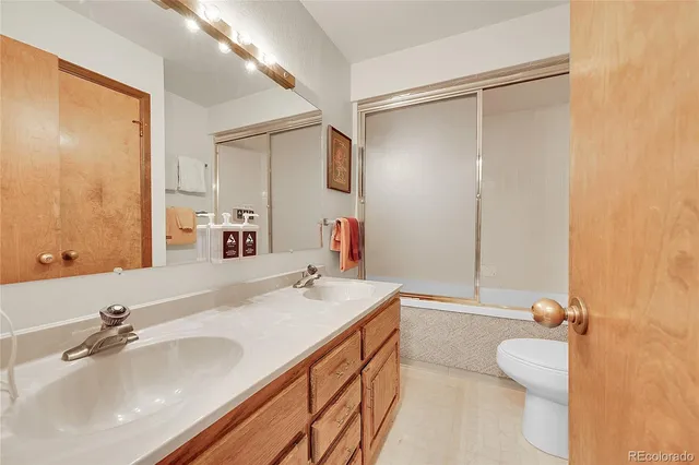 a bathroom with a sink double vanity and a mirror