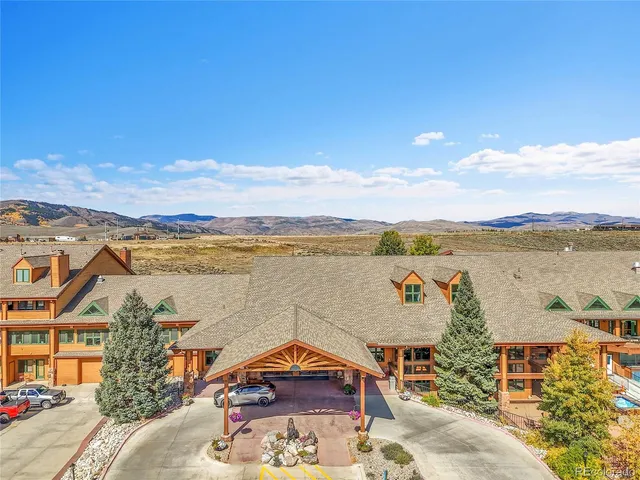 a view of a lake with couches and city view