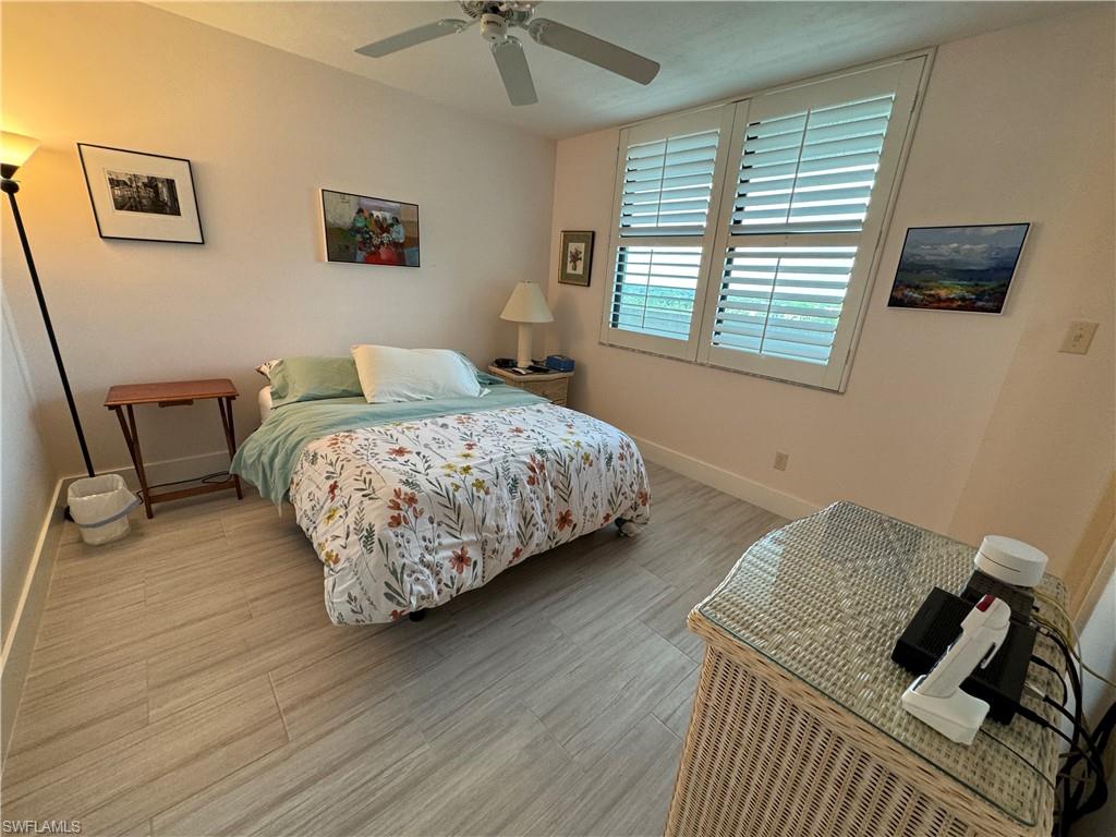6573 Marissa Loop, Unit 902 Naples, FL 34108 - Photo 13 of 26 a bedroom with bed and a window