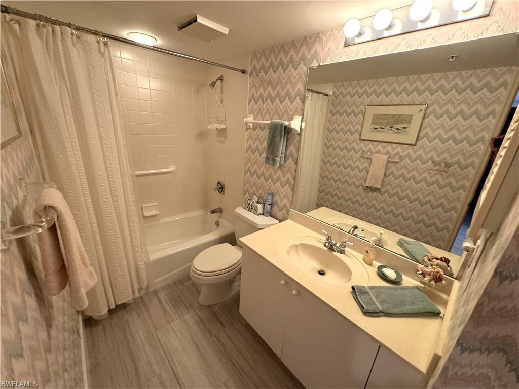 6573 Marissa Loop, Unit 902 Naples, FL 34108 - Photo 14 of 26 a bathroom with a sink a toilet and shower