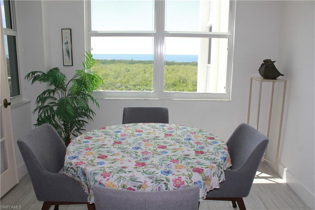 6573 Marissa Loop, Unit 902 Naples, FL 34108 - Photo 8 of 26 a living room with furniture and a potted plant