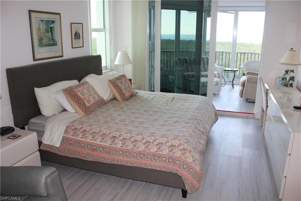 6573 Marissa Loop, Unit 902 Naples, FL 34108 - Photo 9 of 26 a bedroom with a large bed and a large window