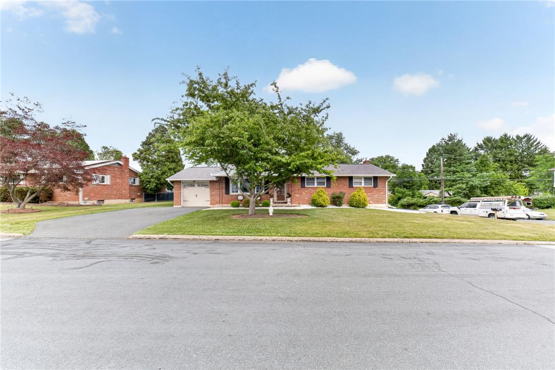 7290 Heather Road Macungie, PA 18062 - Photo 2 of 39 A classic brick-front home featuring a welcoming driveway and mature landscaping.