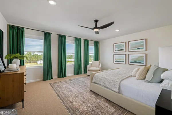 a bedroom with a large bed and a large window