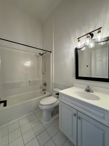 a bathroom with a sink toilet a mirror and shower