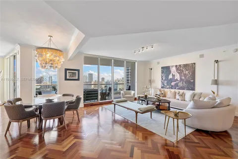 a large kitchen with stainless steel appliances granite countertop a sink refrigerator and chairs