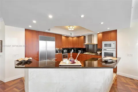 a bathroom with a toilet a sink a mirror and shower