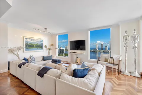 a living room with furniture and a view of kitchen