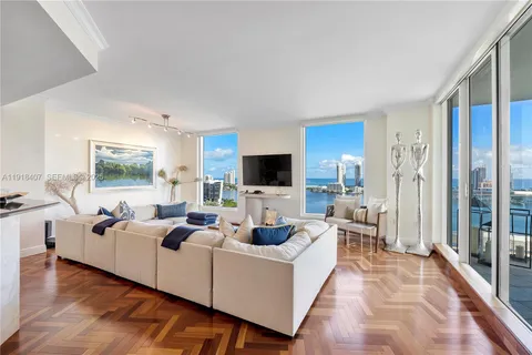 a living room with fireplace furniture and floor to ceiling window