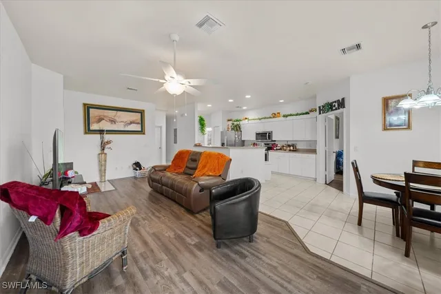 a living room with furniture and kitchen view