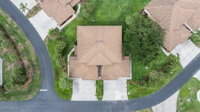 an aerial view of a house with large trees