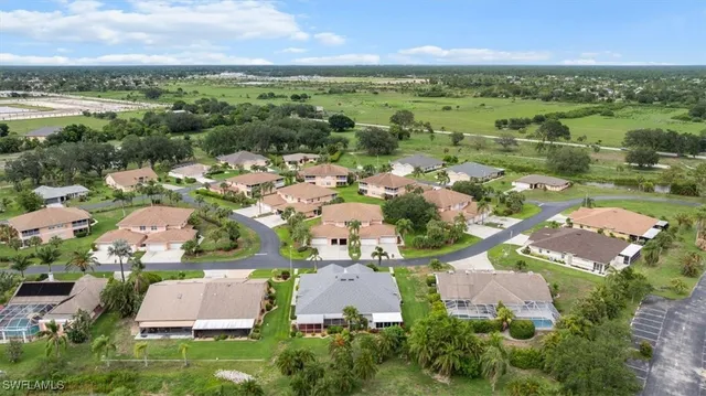 an aerial view of residential houses with outdoor space and river