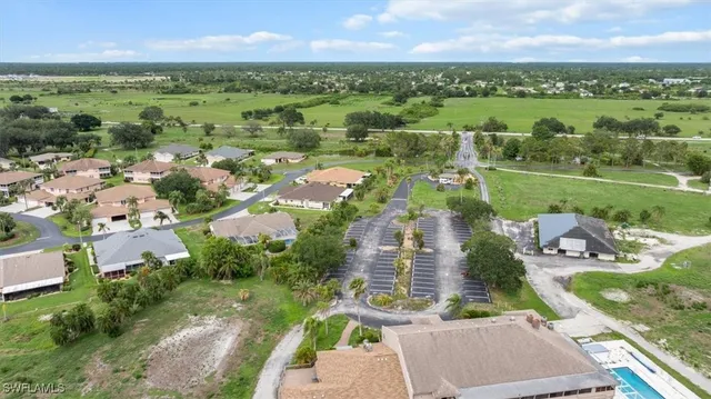 an aerial view of a houses with a yard and lake view