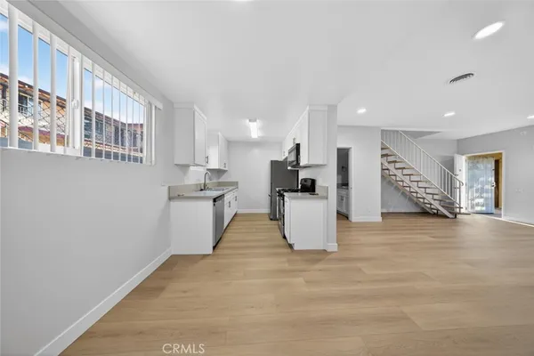 a kitchen with stainless steel appliances a stove a sink and a refrigerator