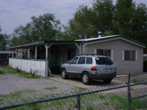 112 Howington Boulevard Seligman, AZ 86337 - Photo 1 of 6 a front view of a house with cars parked