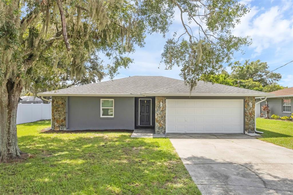 3608 West Wheeler Road Lakeland, FL 33810 - Photo 1 of 1 a house with trees in front of it