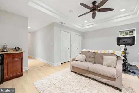 a living room with furniture and a ceiling fan