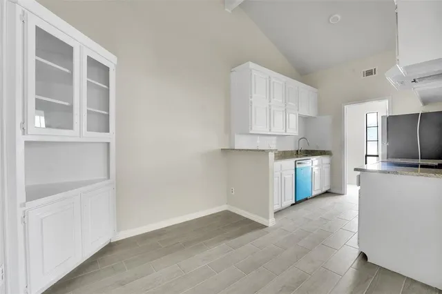 a view of kitchen with wooden floor and electronic appliances