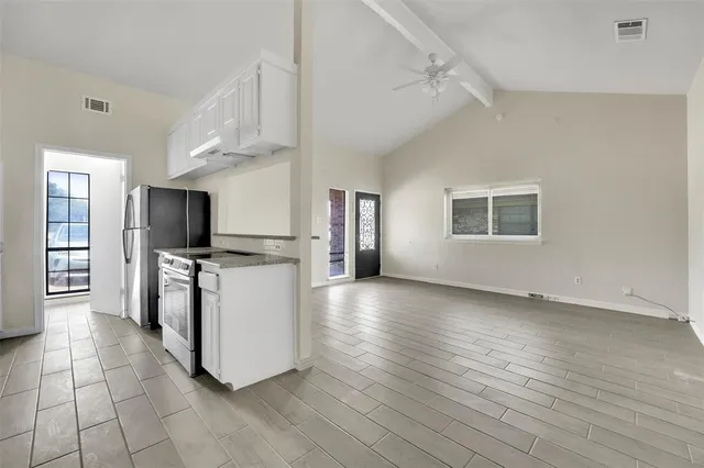 a kitchen with stainless steel appliances granite countertop a stove a sink dishwasher and a refrigerator