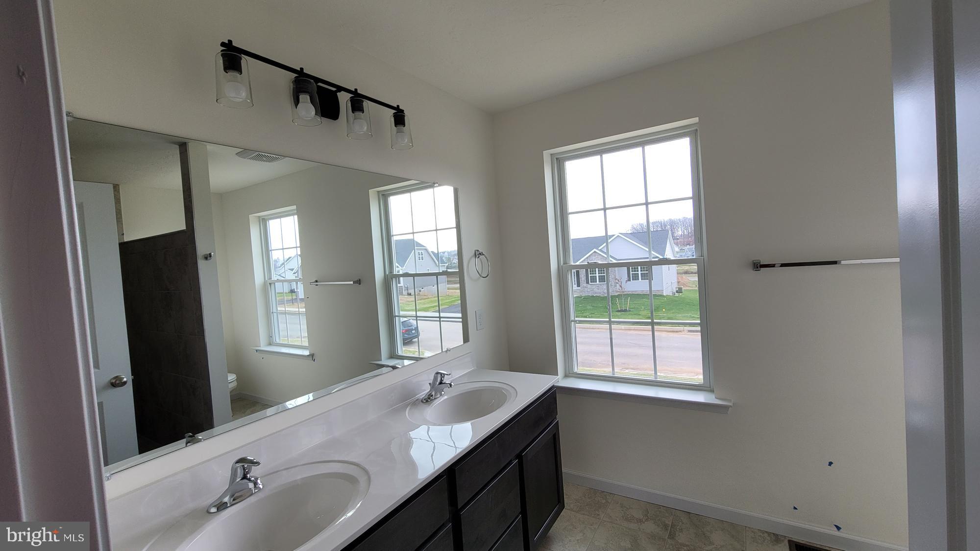 3 Kinzer's Court, Unit 70 Hanover, PA 17331 - Photo 22 of 22 a bathroom with a granite countertop sink and a mirror