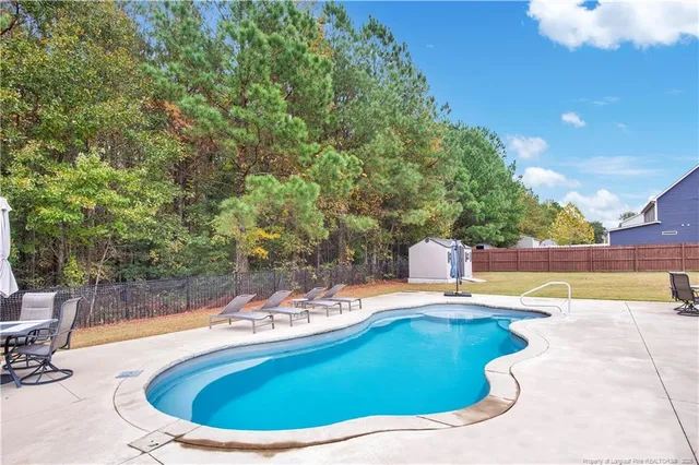 a view of a swimming pool with a yard