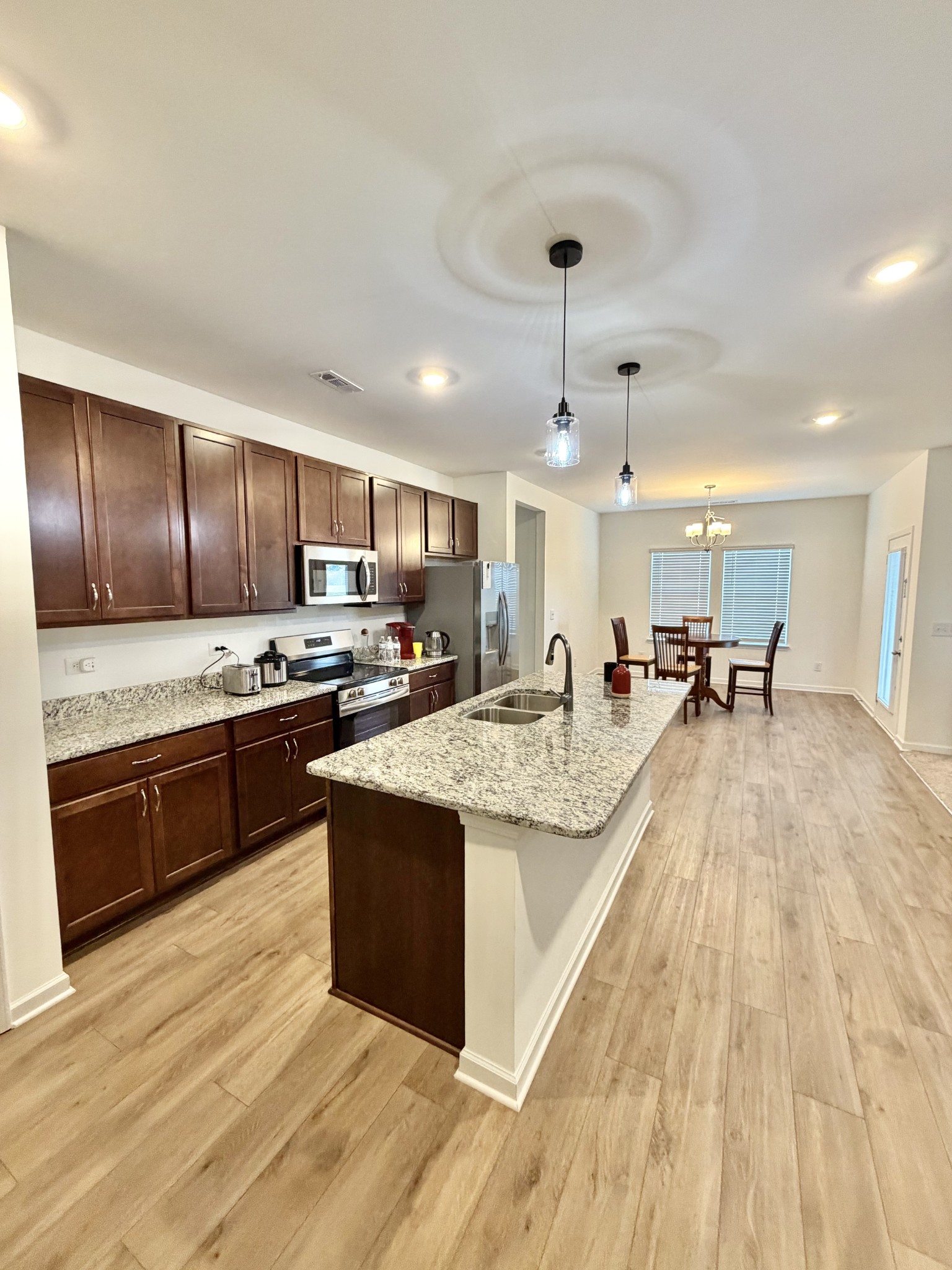 4918 Turquoise Lane Murfreesboro, TN 37129 - Photo 3 of 18 a large kitchen with wooden floors and stainless steel appliances