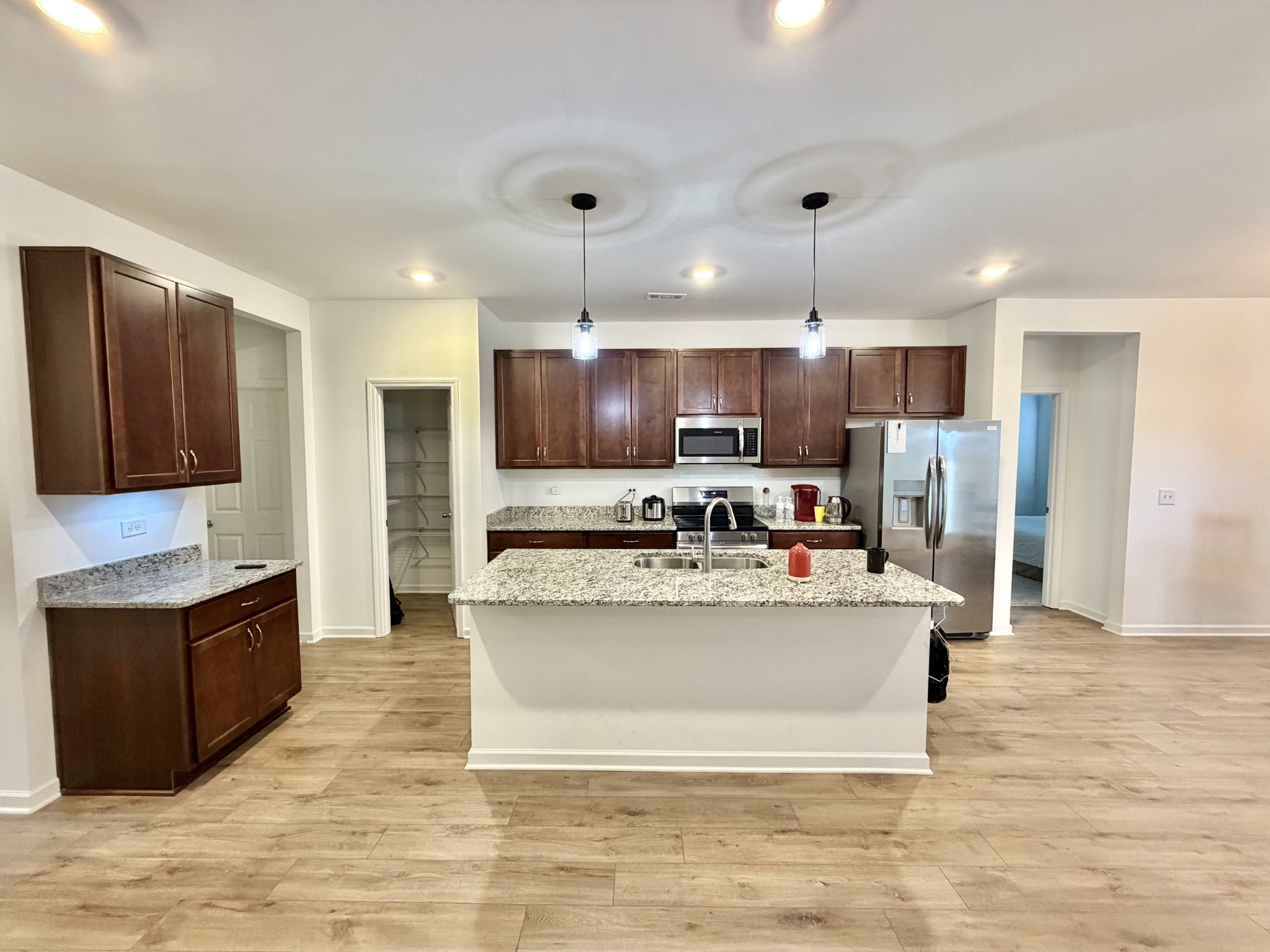 4918 Turquoise Lane Murfreesboro, TN 37129 - Photo 4 of 18 a large kitchen with stainless steel appliances granite countertop a large counter top and a stove
