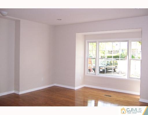1117 New Dover Road Edison, NJ 08820 - Photo 4 of 8 a view of an empty room and window