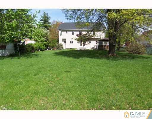 1117 New Dover Road Edison, NJ 08820 - Photo 8 of 8 a view of a white house with a big yard and large tree