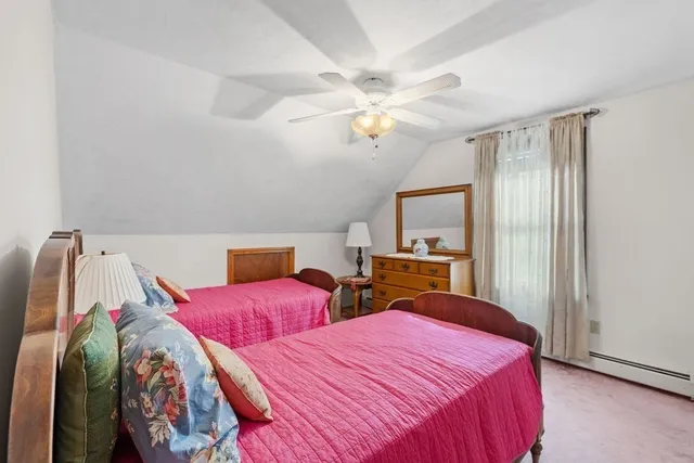a bedroom with two beds and a chandelier