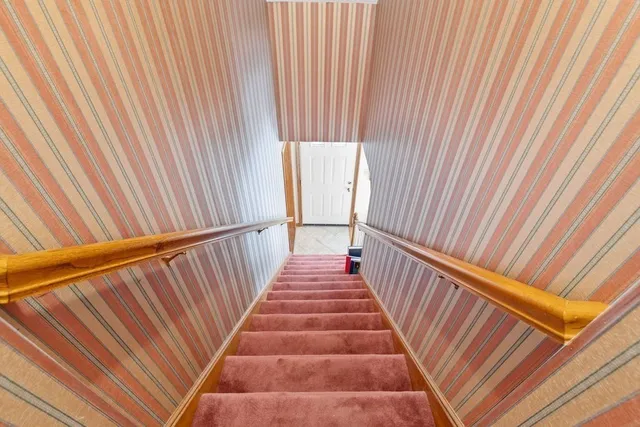 a view of stairs and wooden floor