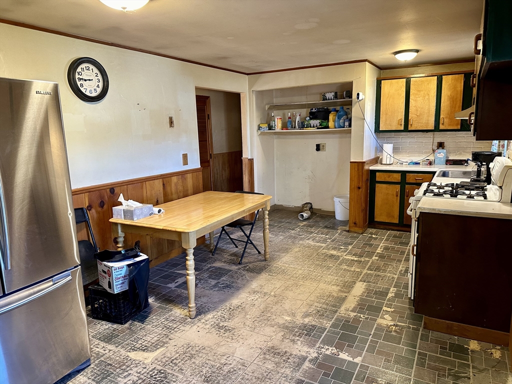 14 Dennis Lane Wareham, MA 02571 - Photo 12 of 33 a view of a kitchen with a dining table and chairs