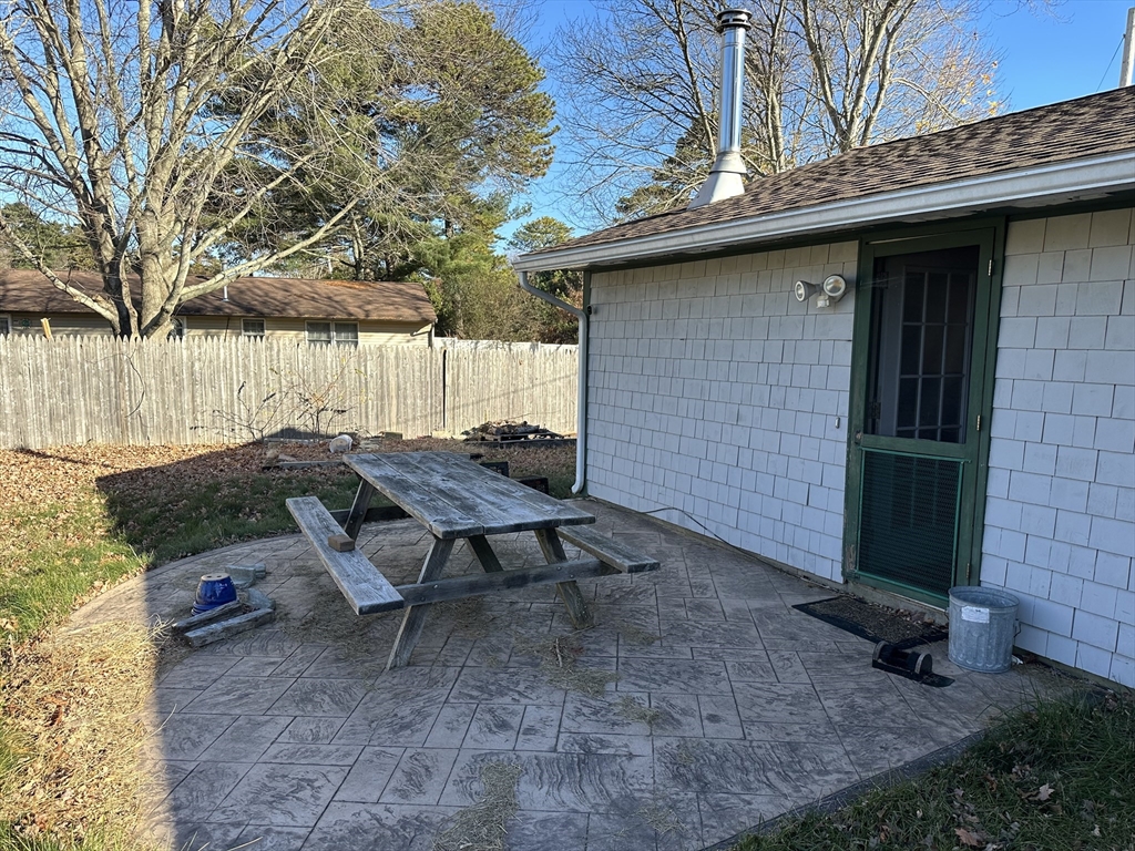 14 Dennis Lane Wareham, MA 02571 - Photo 28 of 33 a backyard of a house with table and chairs