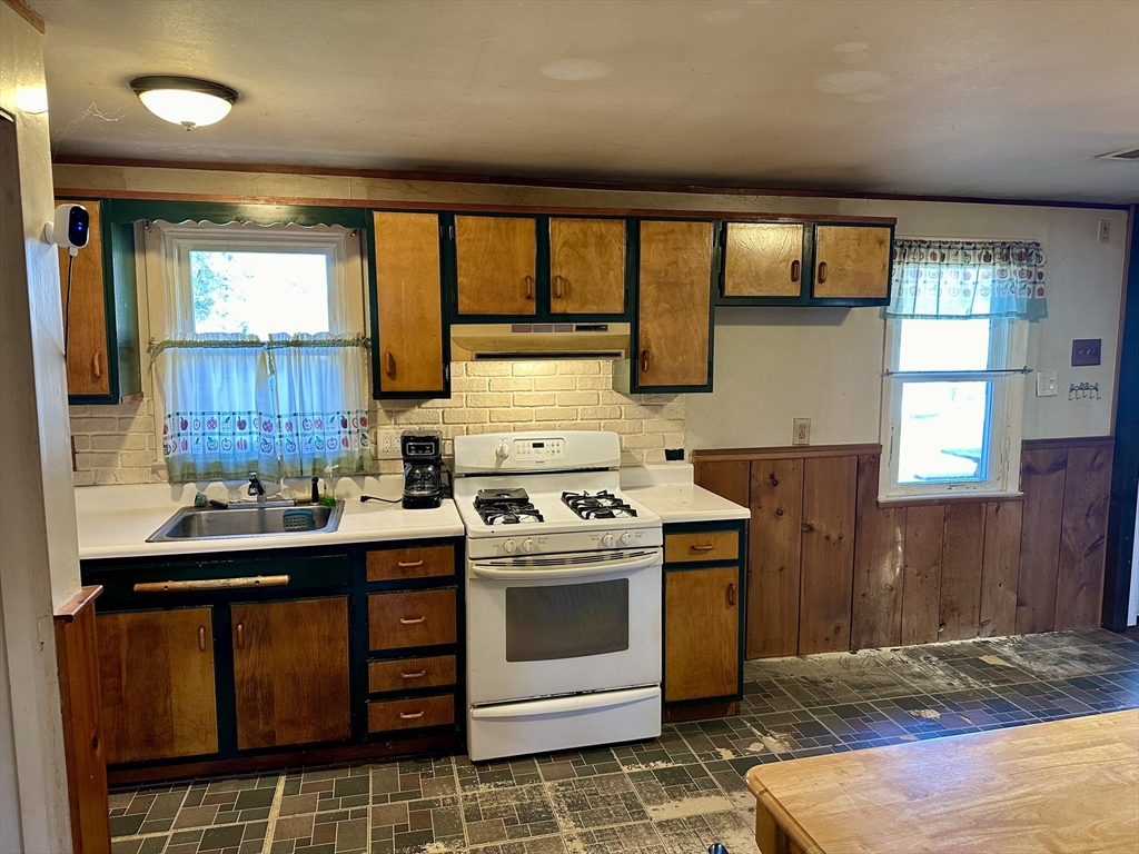 14 Dennis Lane Wareham, MA 02571 - Photo 9 of 33 a kitchen with a stove a sink and a refrigerator