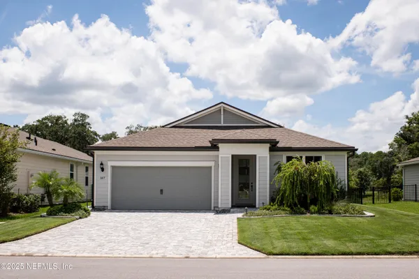 a front view of a house with garden