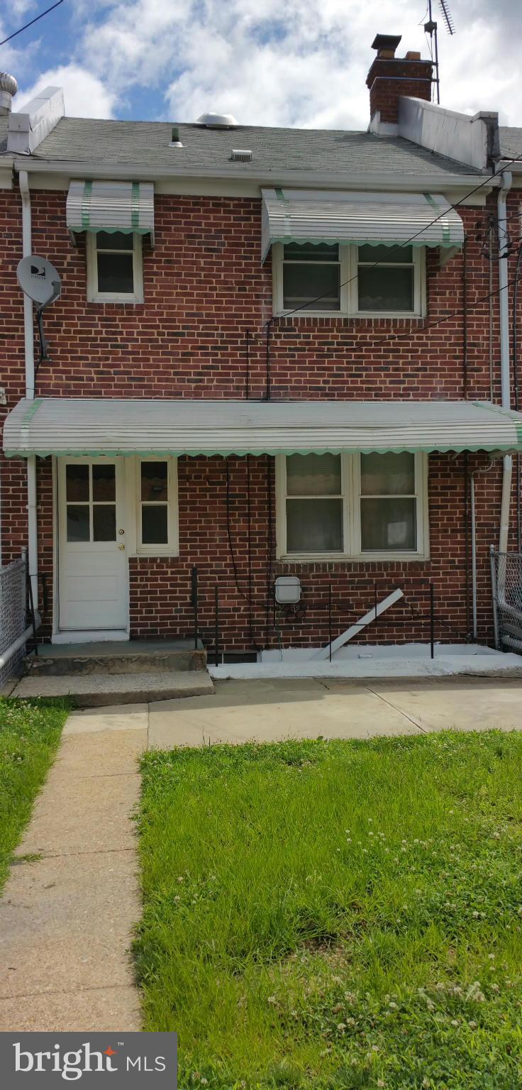 3902 Colchester Road Baltimore, MD 21229 - Photo 2 of 27 a front view of a house with a yard and garage