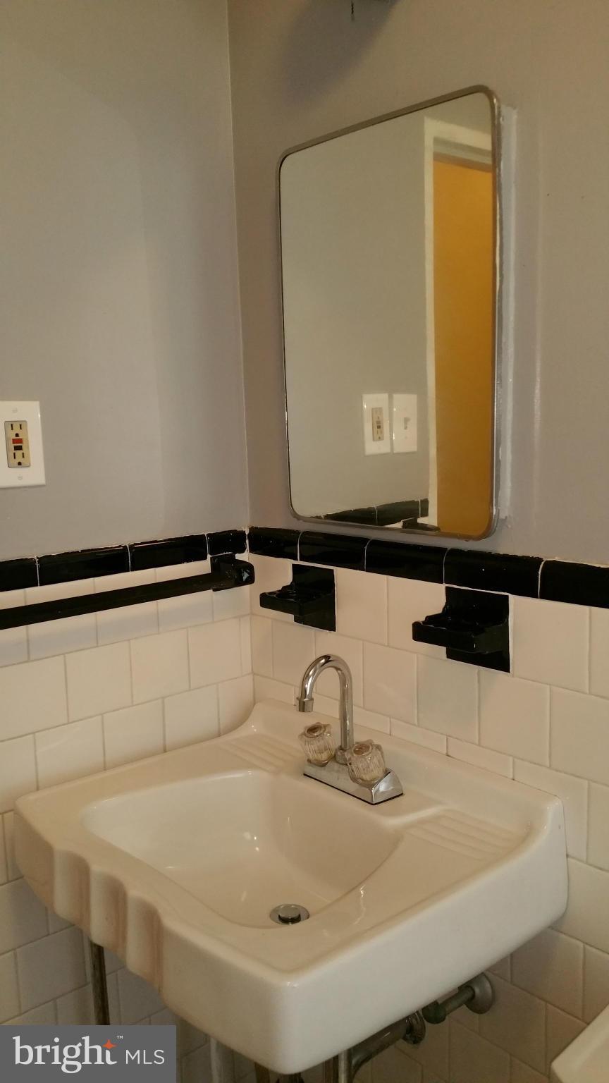 3902 Colchester Road Baltimore, MD 21229 - Photo 14 of 27 a bathroom with a sink and a mirror
