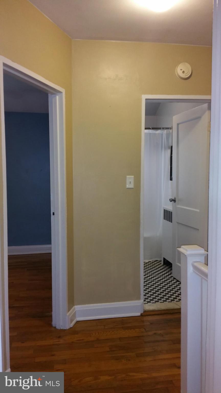 3902 Colchester Road Baltimore, MD 21229 - Photo 19 of 27 a view of a hallway with wooden floor