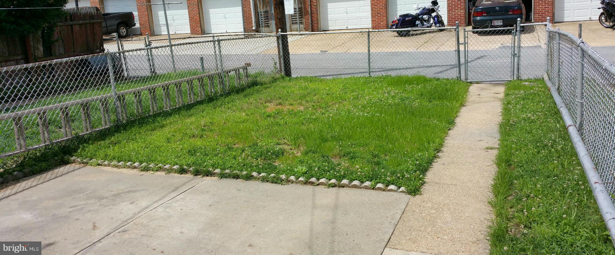 3902 Colchester Road Baltimore, MD 21229 - Photo 3 of 27 a view of a backyard with wooden fence