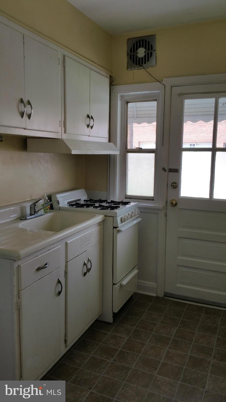 3902 Colchester Road Baltimore, MD 21229 - Photo 9 of 27 a kitchen with granite countertop white cabinets and white appliances