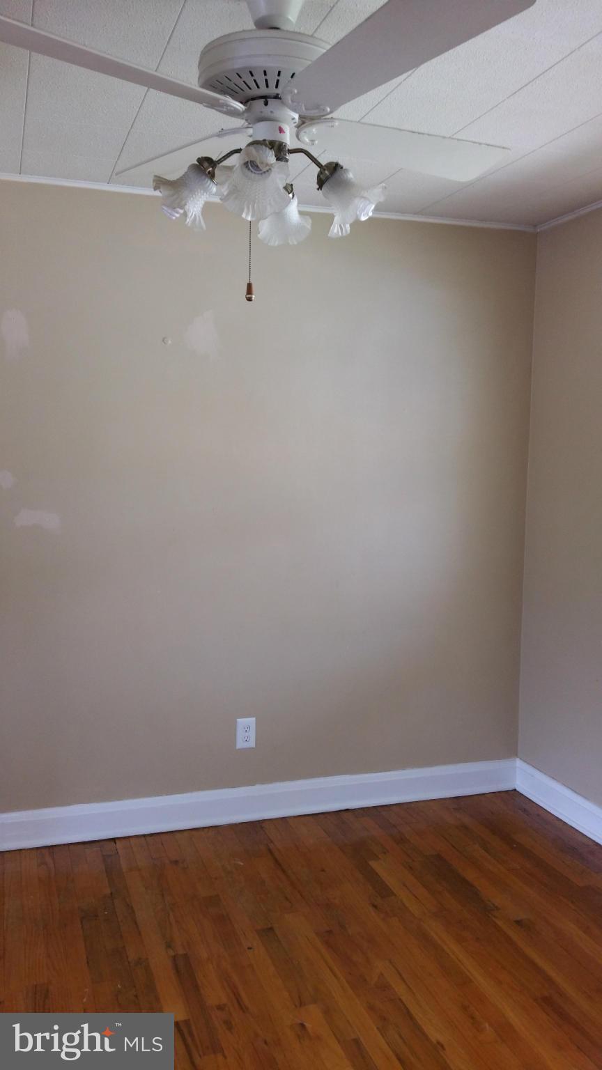 3902 Colchester Road Baltimore, MD 21229 - Photo 10 of 27 a view of an empty room with wooden floor