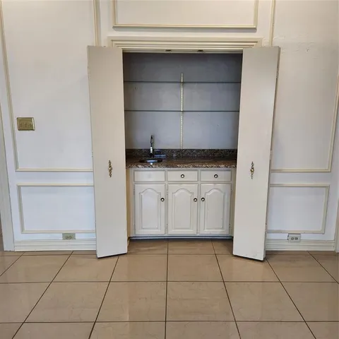 a kitchen with white cabinets and white appliances
