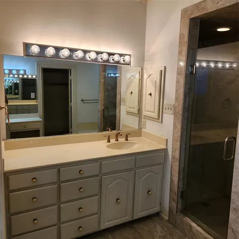a bathroom with a sink double vanity and a mirror